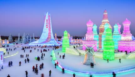 China - People admiring colourful lights in the ice buildings