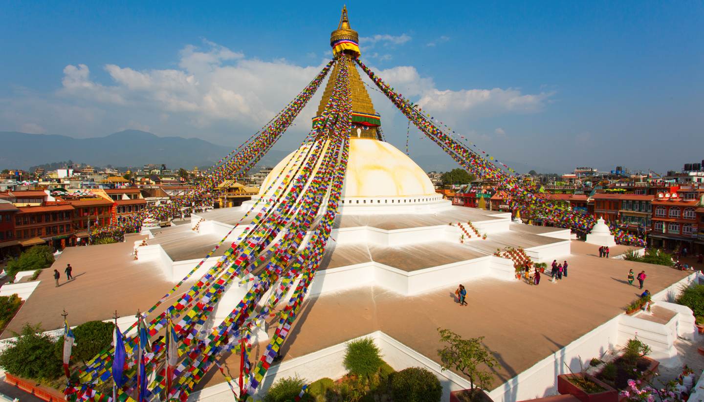 Nepal - People dotted around the Boudhanath stupa in Kathmandu